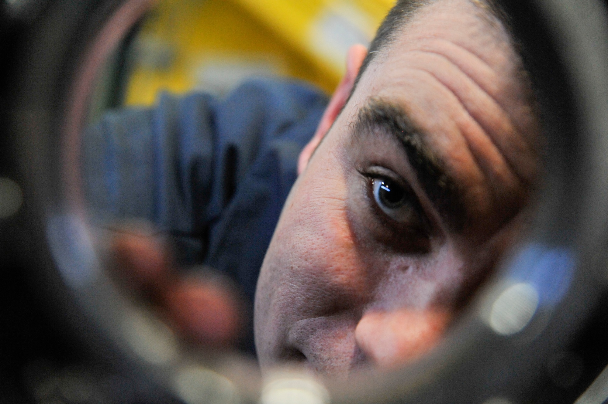U.S. Air Force Staff Sgt. Kyle Bemis, 509th Logistics Readiness Squadron vehicle maintenance craftsman, inspects load bearings on a winch at Whiteman Air Force Base, Mo., Feb. 21, 2014. This procedure ensures no hydraulic fluid is leaking; if there is leaking fluid, it can cause the crane to lock up and drop the load. (U.S. Air Force photo by Airman 1st Class Keenan Berry/Released)