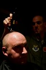 Air crew members from the 23rd Bomb Squadron shave the hair off their heads at Minot Air Force Base, N.D., Feb. 21, 2014. The crew members shaved their heads to support a 5-year-old cancer patient. (U.S. Air Force photo/Senior Airman Brittany Y. Auld)
