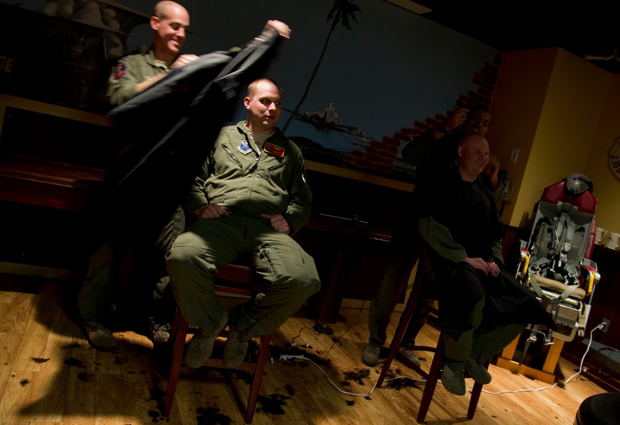 Air crew members from the 23rd Bomb Squadron shave the hair off their heads at Minot Air Force Base, N.D., Feb. 21, 2014. The crew members shaved their heads to support a 5-year-old cancer patient. (U.S. Air Force photo/Senior Airman Brittany Y. Auld)