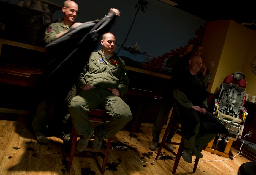 Air crew members from the 23rd Bomb Squadron shave the hair off their heads at Minot Air Force Base, N.D., Feb. 21, 2014. The crew members shaved their heads to support a 5-year-old cancer patient. (U.S. Air Force photo/Senior Airman Brittany Y. Auld)