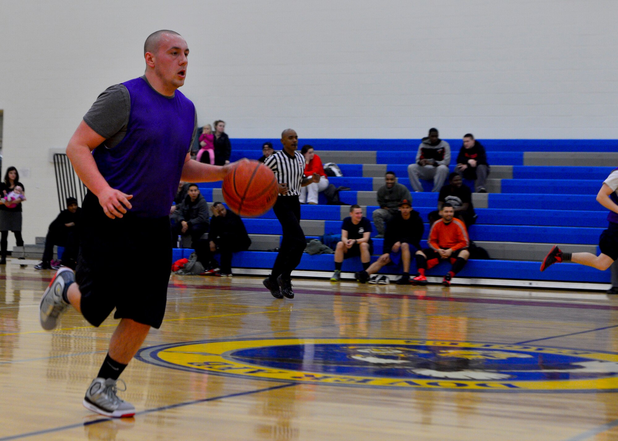Troy Page, 436th Aerial Port Squadron, drives the ball down court during an intramural basketball game Feb. 27, 2014, at the fitness center on Dover Air Force Base, Del. The 436th APS was able to hold the 436th Maintenance Squadron to just ten points in the second half. (U.S. Air Force photo/Airman 1st Class Zachary Cacicia)