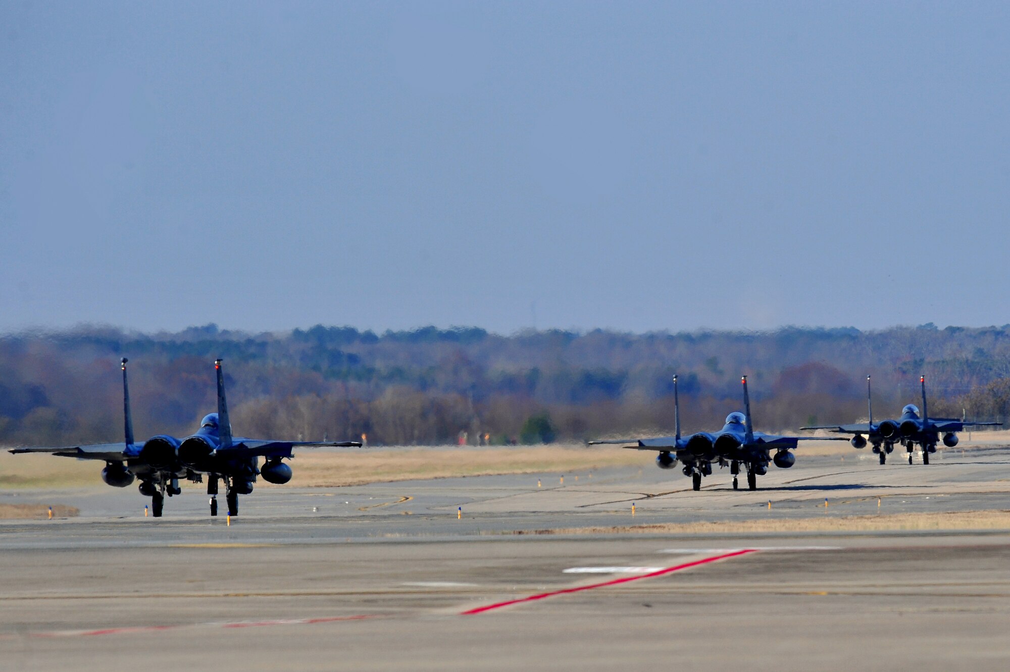Three F-15E Strike Eagles, assigned to the 4th Fighter Wing, taxi down the runway in preparation for takeoff Feb. 28, 2014, at Seymour Johnson Air Force Base, N.C. The aircraft will depart for Nellis Air Force Base, Nev., in order to participate in Red Flag 14-2. Red Flag is a realistic combat training exercise that incorporates all spectrums of warfare including command and control, real-time intelligence, analysis and exploitation, and electronic warfare. (U.S. Air Force photo/Airman 1st Class Shawna L. Keyes) 