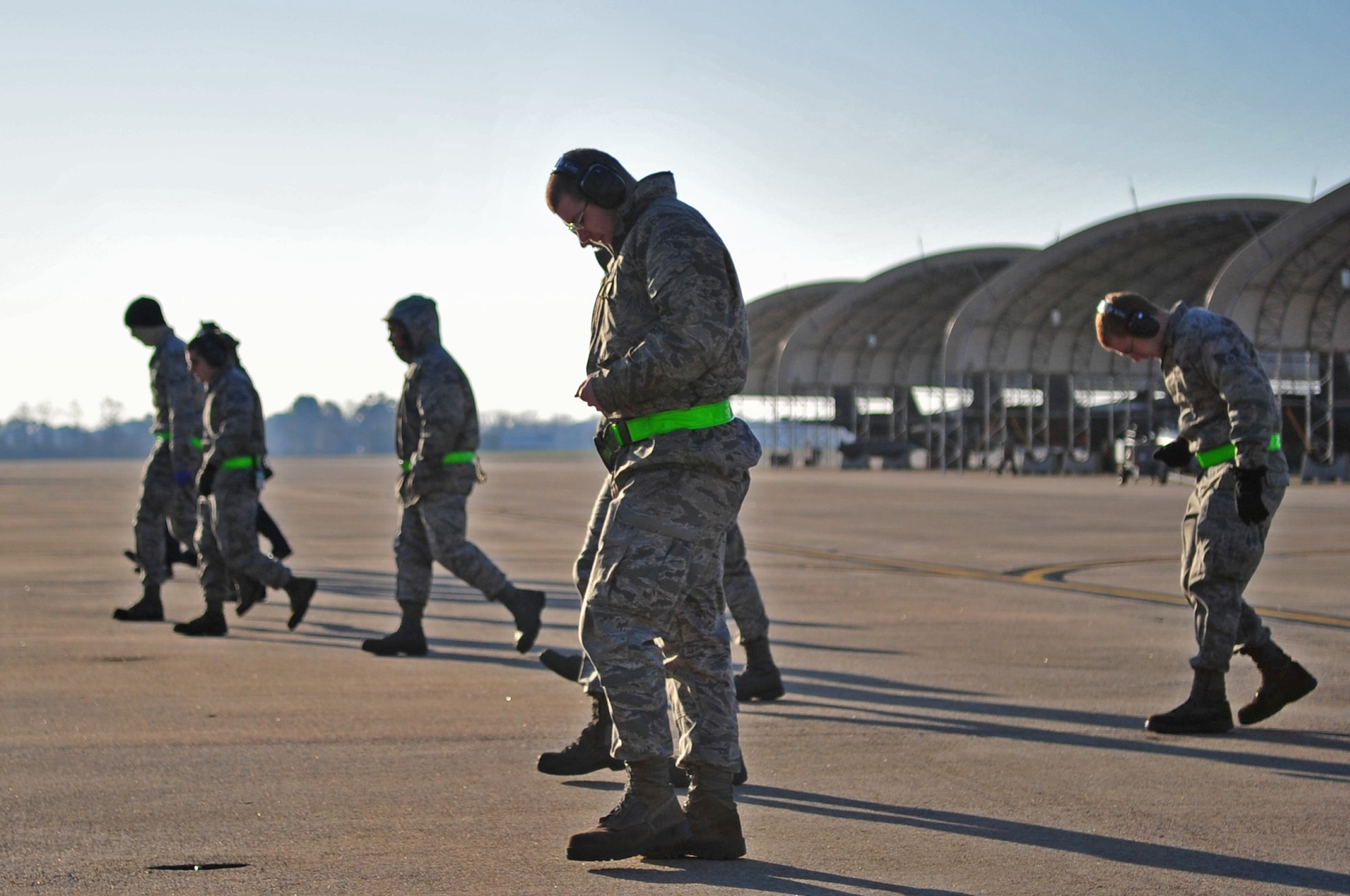Airmen from the 4th Aircraft Maintenance Squadron, perform a foreign object debris walk, Feb. 28, 2014, at Seymour Johnson Air Force Base, N.C. A FOD walk is a necessary safety precaution meant to ensure the taxiway is free from particles that might damage an aircraft intake.  (U.S. Air Force photo/Airman 1st Class Shawna L. Keyes)
