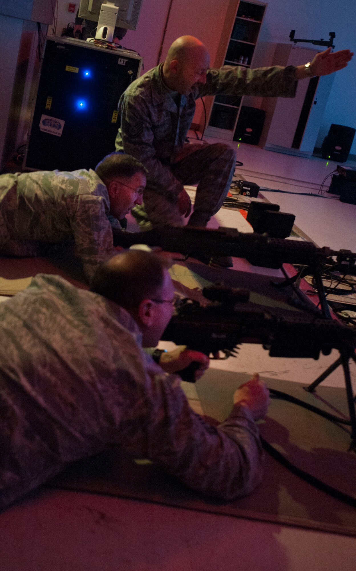 Maj. Gen. Scott Vander Hamm, Eighth Air Force commander, and Chief Master Sgt. Anderson, Eighth Air Force command chief, practice their aim on the firing simulator at Minot Air Force Base, N.D., Feb. 25, 2014. Vander Hamm and Anderson visited Minot AFB Feb. 21-18 to learn about the 5th Bomb Wing’s mission first-hand. (U.S. Air Force photo/Airman 1st Class Apryl Hall)