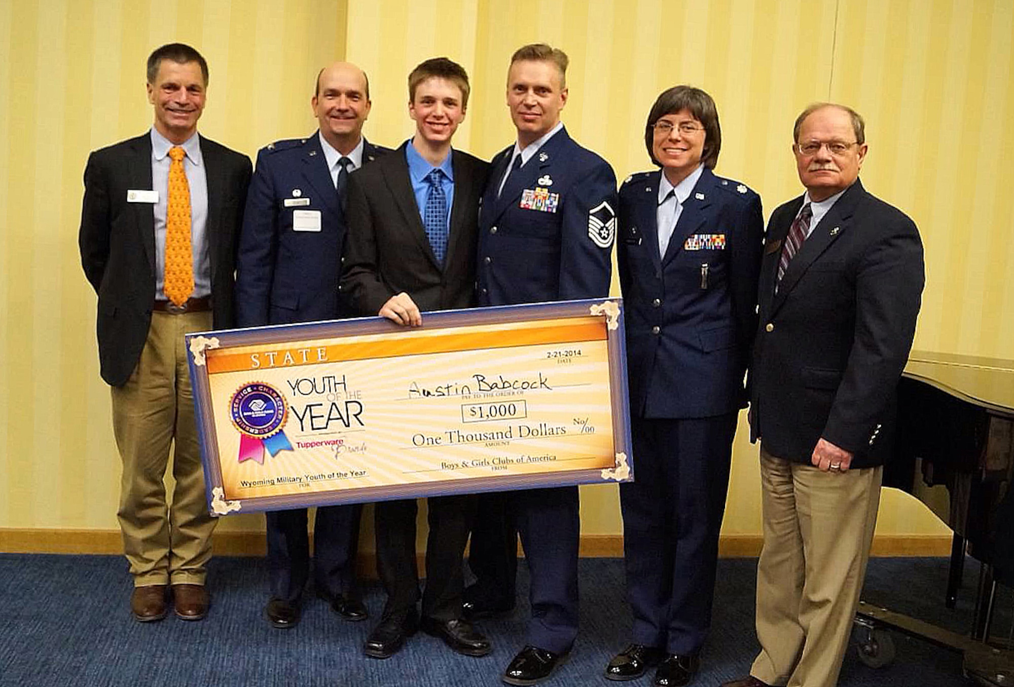 Austin Babcock, Wyoming’s Military Youth of the Year, poses with Mark Gordon, Wyoming’s State Treasurer; Col. Trevor Flint, 90th Maintenance Group commander; Master Sgt. Karl Babcock, 90th Aerospace Ground Equipment noncommissioned officer in charge; Lt. Col. Maggie Vencius, 90th Maintenance Operations Squadron commander; and Mayor Richard Kaysen, Mayor of Wyoming, after being presented with the Wyoming’s Military Youth of the Year scholarship at an awards ceremony event Feb. 21.  