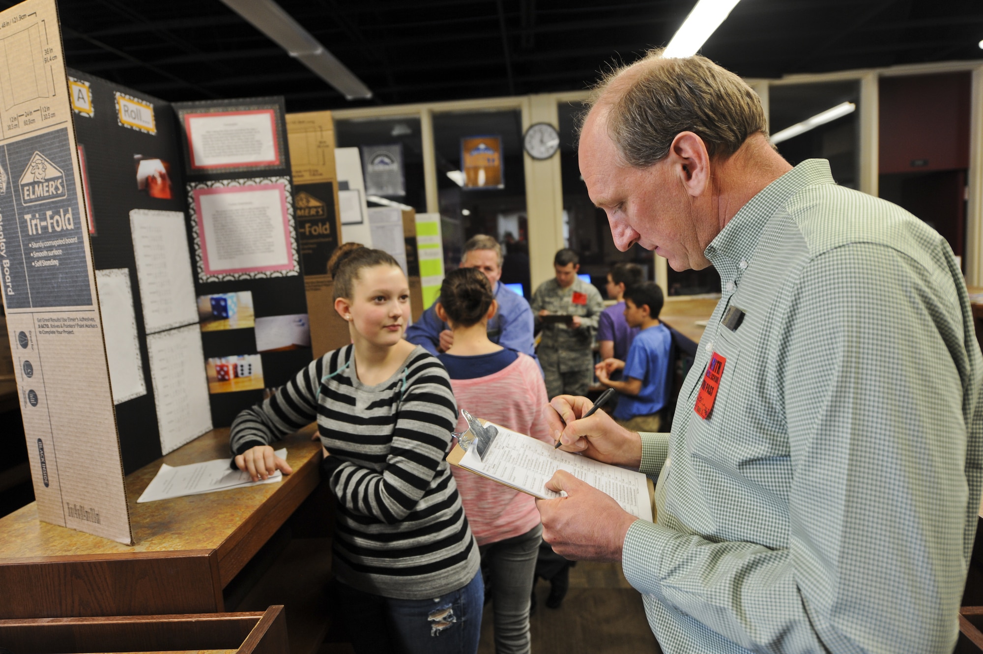 COLORADO SPRINGS, Colo. -- Stan Cindrity, 21st Force Support Squadron school liaison officer, grades a science project Feb. 24 at North Middle School in Colorado Springs. Cindrity liaises between Peterson Air Force Base, Colo., and Colorado Springs schools. One of his duties is organizing volunteer efforts. (U.S. Air Force photo/Staff Sgt. Jacob Morgan)