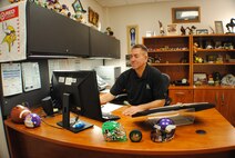 Darwin “D. J.” Garman, 319th Medical Group Commander Support Staff flight chief, checks e-mail Mar. 3, 2014, in his office inside the Medical Treatment Facility on Grand Forks Air Force Base, N.D. Garman is the base’s Warrior of the Week for the first week of March 2014. (U.S. Air Force photo/Staff Sgt. Luis Loza Gutierrez) 
