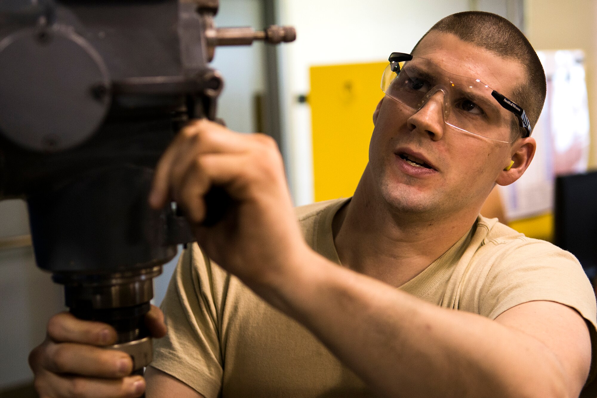 U.S. Air Force Senior Airman Travis Reuther makes adjustments to a drill press before beginning a project, Mar. 2, 2014, Barksdale Air Force Base, La. Reuther is a metal technician assigned to the 307th Maintenance Squadron. (U.S. Air Force photo by Master Sgt. Greg Steele/Released)