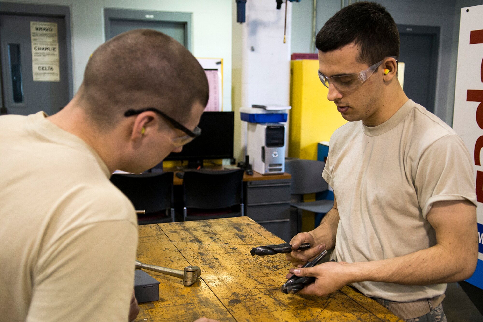 U.S. Air Force Senior Airmen Matt Windmann (right) and Travis Reuther select the right drill bit for a job, Mar. 2, 2014, Barksdale Air Force Base, La. Both Airmen are metal technicians assigned to the 307th Maintenance Squadron. (U.S. Air Force photo by Master Sgt. Greg Steele/Released)