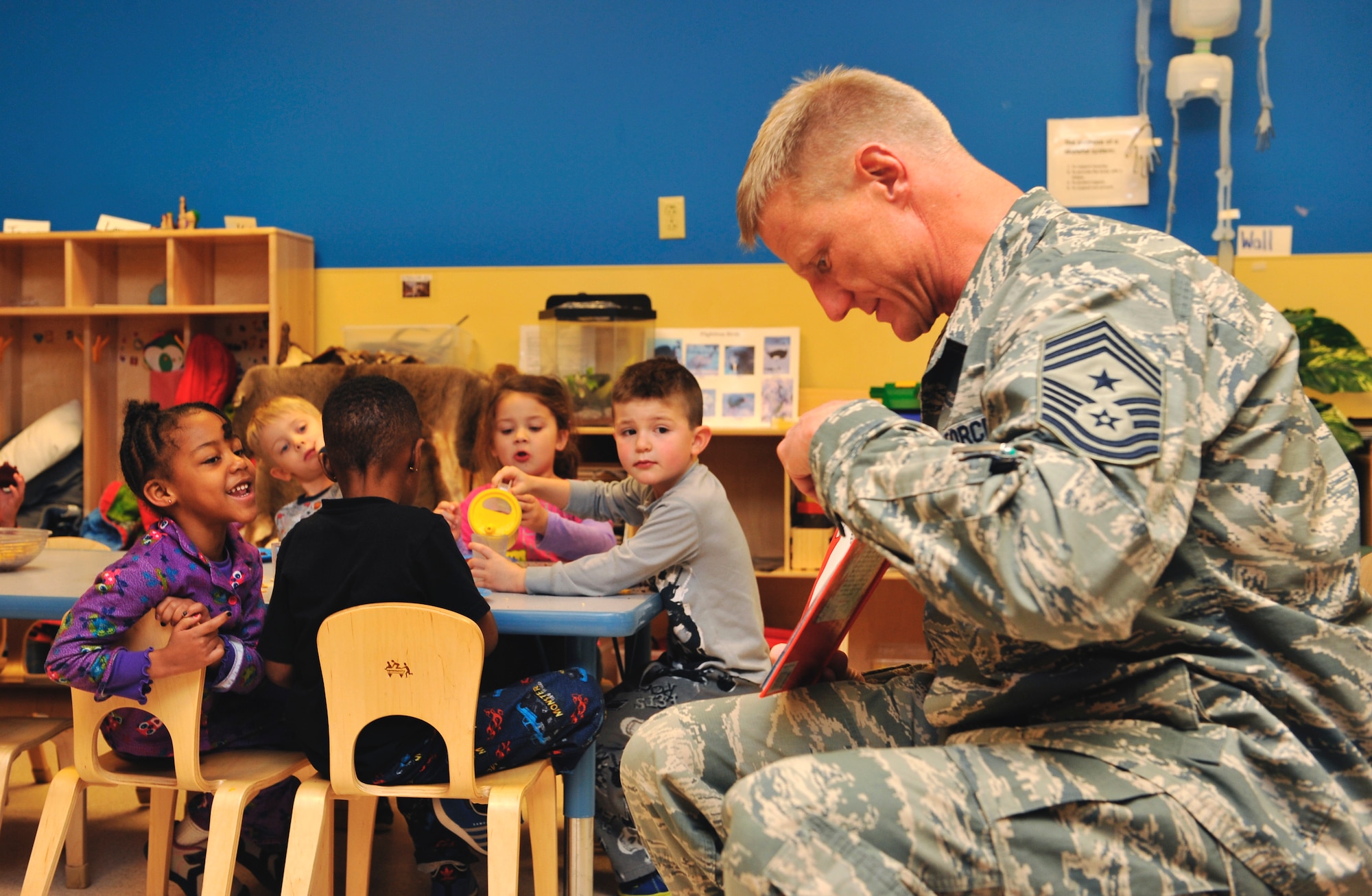 Chief Master Sgt. Craig S. Hall, 460th Space Wing command chief, reads a Dr. Seuss book to a preschool class Feb. 28, 2014, at the A-Basin Child Development Center on Buckley Air Force Base, Colo. Hall read to the children during their snack time to celebrate Dr. Seuss’s birthday. (U.S. Air Force photo by Airman 1st Class Samantha Saulsbury/Released)