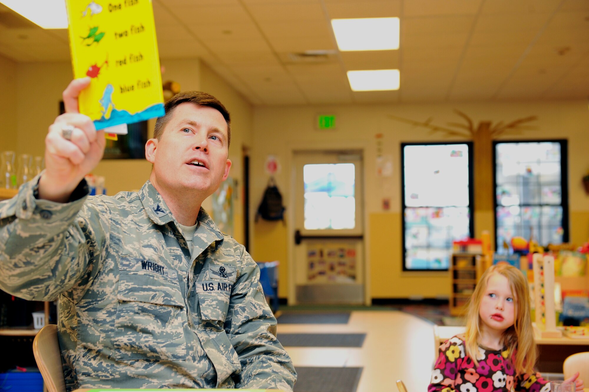 Col. Dan Wright, 460th Space Wing commander, reads “One Fish Two Fish Red Fish Blue Fish” to a preschool class Feb. 28, 2014, at the A-Basin Child Development Center on Buckley Air Force Base, Colo. Wright read to the children during their snack time to celebrate Dr. Seuss’s birthday. (U.S. Air Force photo by Airman 1st Class Samantha Saulsbury/Released)