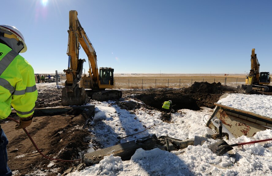 Contractors unwind cable that will be used to pull the launcher closure door off Launch Facility R-29, Pondera County, Mont., on Feb. 25. A 9-foot deep hole was dug to bury the 110-ton launcher closure door and the dirt from the hole was used to fill in the silo. (U.S. Air Force photo/Senior Airman Katrina Heikkinen)