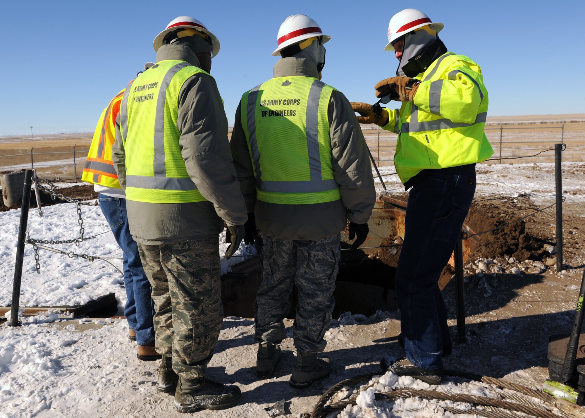 Alan Kornlien, U.S. Army Corps of Engineers project engineer (right), explains to Col. Robert Stanley, 341st Missile Wing commander (center), and Chief Master Sgt. Phillip Easton, 341st MW command chief (left), how the launcher closure door will be pulled off at Launch Facility R-29 in Pondera County, Mont., on Feb. 25. The deconstruction of 103 deactivated intercontinental ballistic missile launch facilities are comprised of 50 deactivated Minuteman III launch facilities here, 50 deactivated Peacekeeper facilities at F.E. Warren AFB., Wyo., and three test launchers at Vandenberg AFB., Calif. (U.S. Air Force photo/Senior Airman Katrina Heikkinen)