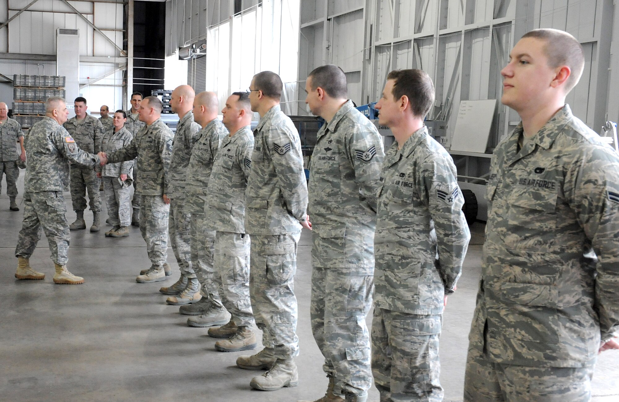 U.S. Army Maj. Gen. Jeff W. Mathis III, commander, Joint Task Force Civil Support, presents coins to airmen of the 633rd Logistics Readiness Squadron during his visit to Joint Base Langley-Eustis, Va., Feb. 26, 2014.  Mathis presented commander coins to show his appreciation to the squadron for providing assistance during a recent JTF-CS no-notice deployment readiness exercise (DRE). Internal exercises, such as DREs, ensure the unit's preparedness to support local first responders in the event of a man-made or a natural disaster in the United States. JTF-CS anticipates, plans, and prepares for Chemical, Biological, Radiological, and Nuclear Defense Support of Civil Authorities (CBRN-DSCA) response operations. (DOD photo by U.S. Navy Petty Officer 1st Class Brian Dietrick/Released)