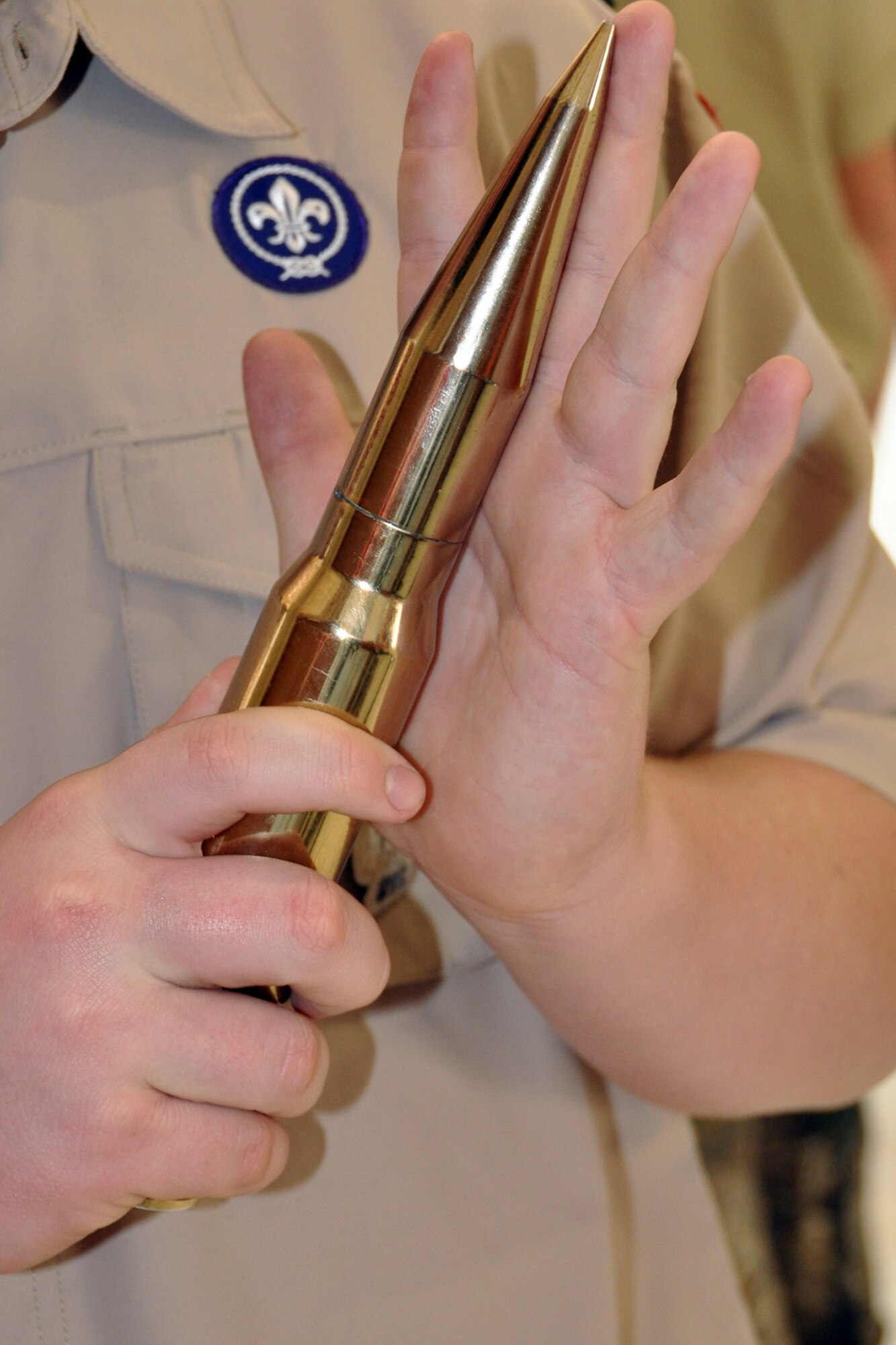 A boy scout with Troop 531 out of Angleton, Texas, examines the shell of an A-10 bullet at the 307th Bomb Wing Engine Shop March 1, 2014. The Troop visited Barksdale Air Force Base, La., for an orientation tour including visits to the munitions storage area, life support, B-52 static display and Global Power Museum.  (U.S. Air Force photo by Master Sgt. Mary Hinson/Released)