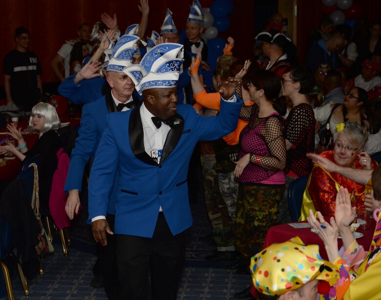 Kappensitzung crew members head to the stage during the inaugural Saber Kappensitzung at Club Eifel on Spangdahlem Air Base, Germany, Feb. 28, 2014. The crew presided over the entertainment and led the audience in chants throughout the evening.  (U.S. Air Force photo by Staff Sgt. Joe W. McFadden/Released)