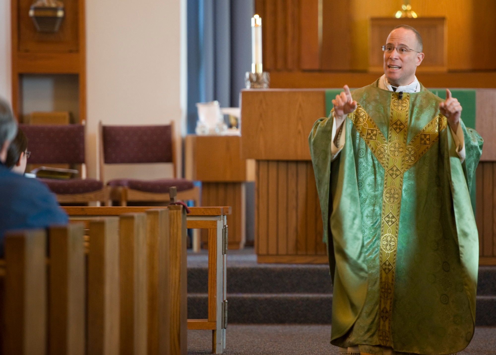 Chaplain (Capt.) Louis Mattina, 436th Airlift Wing chaplain, gives a homily to parishioners during Sunday Catholic Mass Feb. 23, 2014, at Chapel Two on Dover Air Force Base, Del. Mattina, a Roman Catholic priest, has been selected by his leadership to be highlighted for his outstanding pastoral work. (U.S. Air Force photo/Airman 1st Class Zachary Cacicia) 