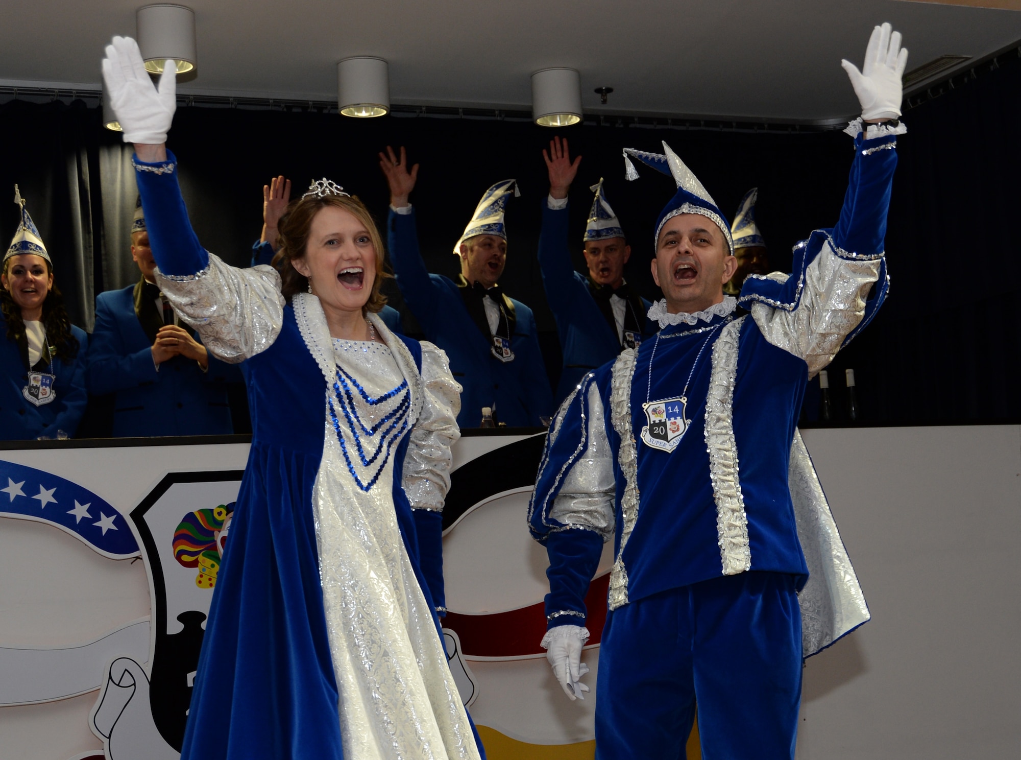 U.S. Air Force Col. David Julazadeh, commander of the 52nd Fighter Wing, right, waves to a crowd alongside his wife, Kate,  during the inaugural Saber Kappensitzung  at Club Eifel on Spangdahlem Air Base, Germany, Feb. 28, 2014. The Julazadehs served as the prince and princess of the Kappensitzung court as well as the host for the evening’s festivities.  (U.S. Air Force photo by Staff Sgt. Joe W. McFadden/Released) 