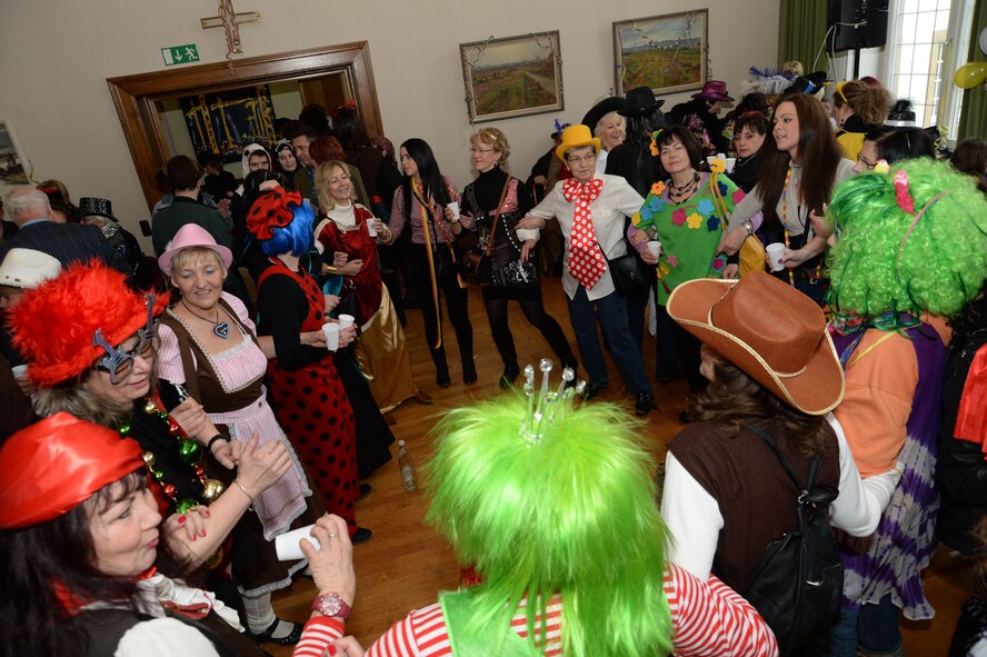 Revelers lock arms and dance to music as part of a Fasching celebration at the city hall in Bitburg, Germany, Feb. 27, 2014. Fasching is a yearly celebration put on by the Germans to commemorate the start of the spring season. (U.S. Air Force photo by Staff Sgt. Joe W. McFadden/Released)