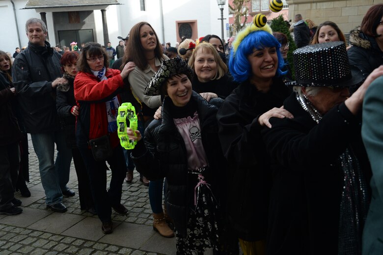 U.S. Air Force Col. Jill Scheckel, 52nd Medical Group commander, center, shakes a tambourine as part of a party line during a Fasching celebration at the city hall in Bitburg, Germany, Feb. 27, 2014. Spangdahlem Airmen joined hundreds of Bitburg residents as part of a Fasching party in the city. (U.S. Air Force photo by Staff Sgt. Joe W. McFadden/Released)