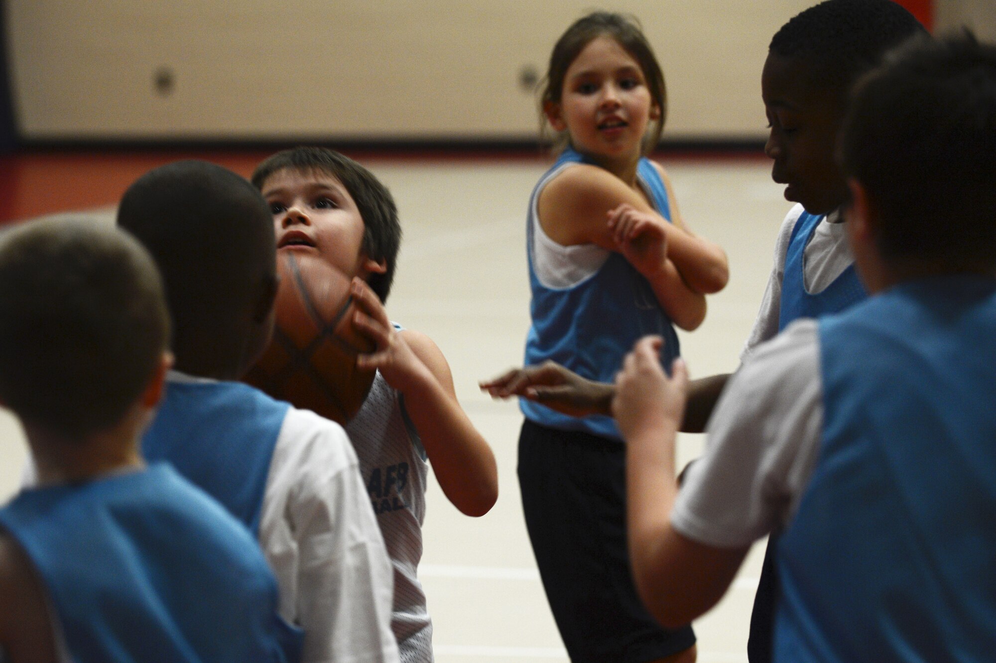 A child sets himself up to shoot a basketball in the hoop at the Youth Center on Shaw Air Force Base, S.C., Feb. 25, 2014. The sports program is open to all dependents of active duty, Guard, Reserve, civilians, and retirees. (U.S. Air Force photo by Airman 1st Class Diana M. Cossaboom/Released)