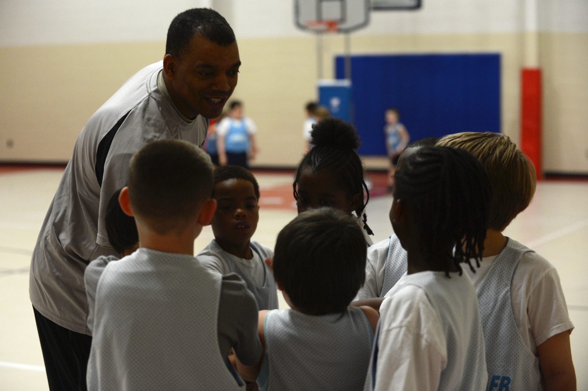U.S. Air Force Master Sgt. Cohen Young, 20th Fighter Wing Public Affairs superintendent, discusses basketball strategy with his team at the Youth Center on Shaw Air Force Base, S.C., Feb. 25, 2014. The Youth Center sports program provides children the opportunities to learn the fundamentals of various sports. (U.S. Air Force photo by Airman 1st Class Diana M. Cossaboom/Released)
