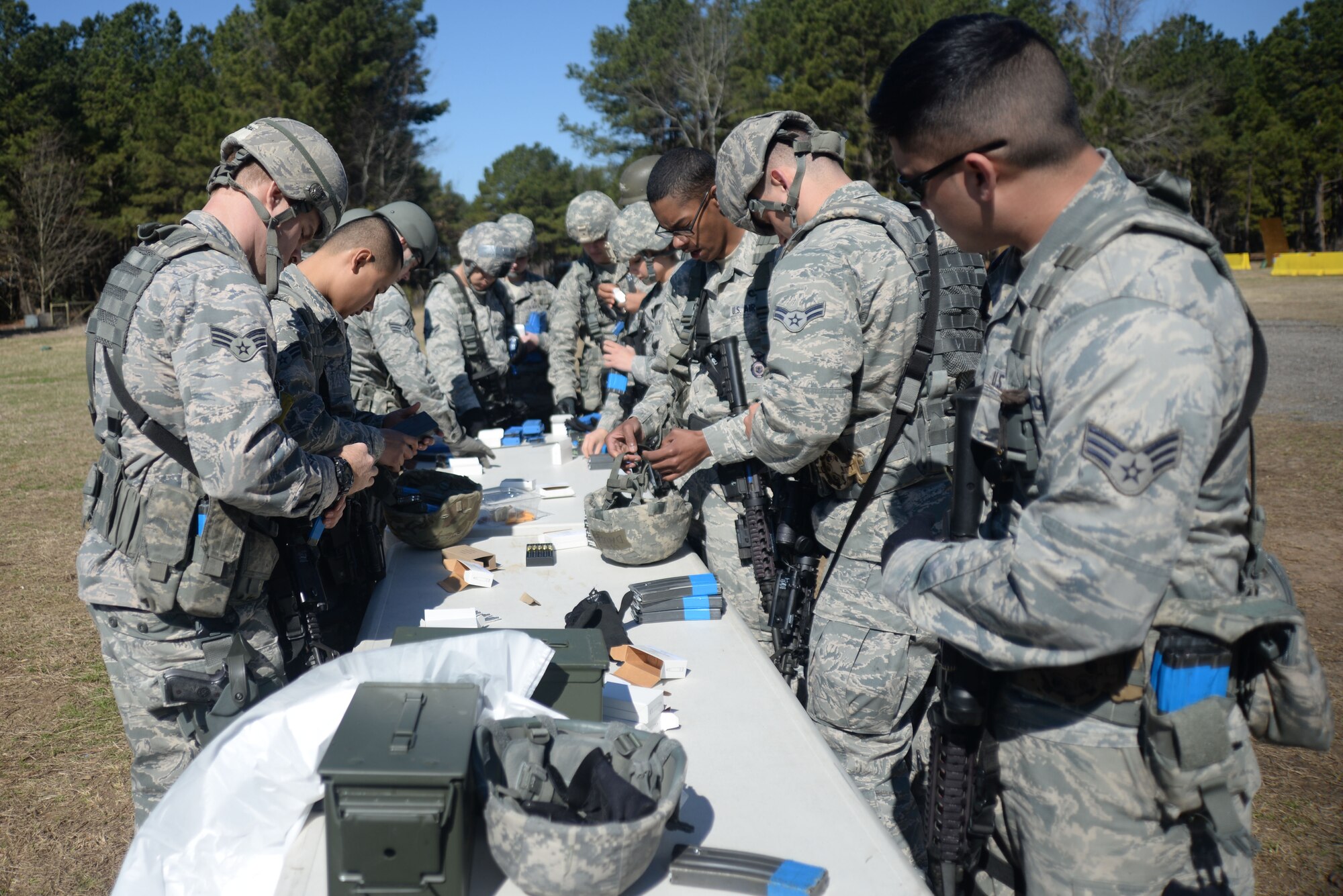 Airmen from the 20th Security Forces Squadron load simulation rounds for a training exercise at Shaw Air Force Base, S.C., Feb. 28, 2014. The Airmen performed in two-man fire team movements using techniques similar to those that they could potentially use while deployed. (U.S. Air Force photo by Airman 1st Class Michael A. Cossaboom/Released)