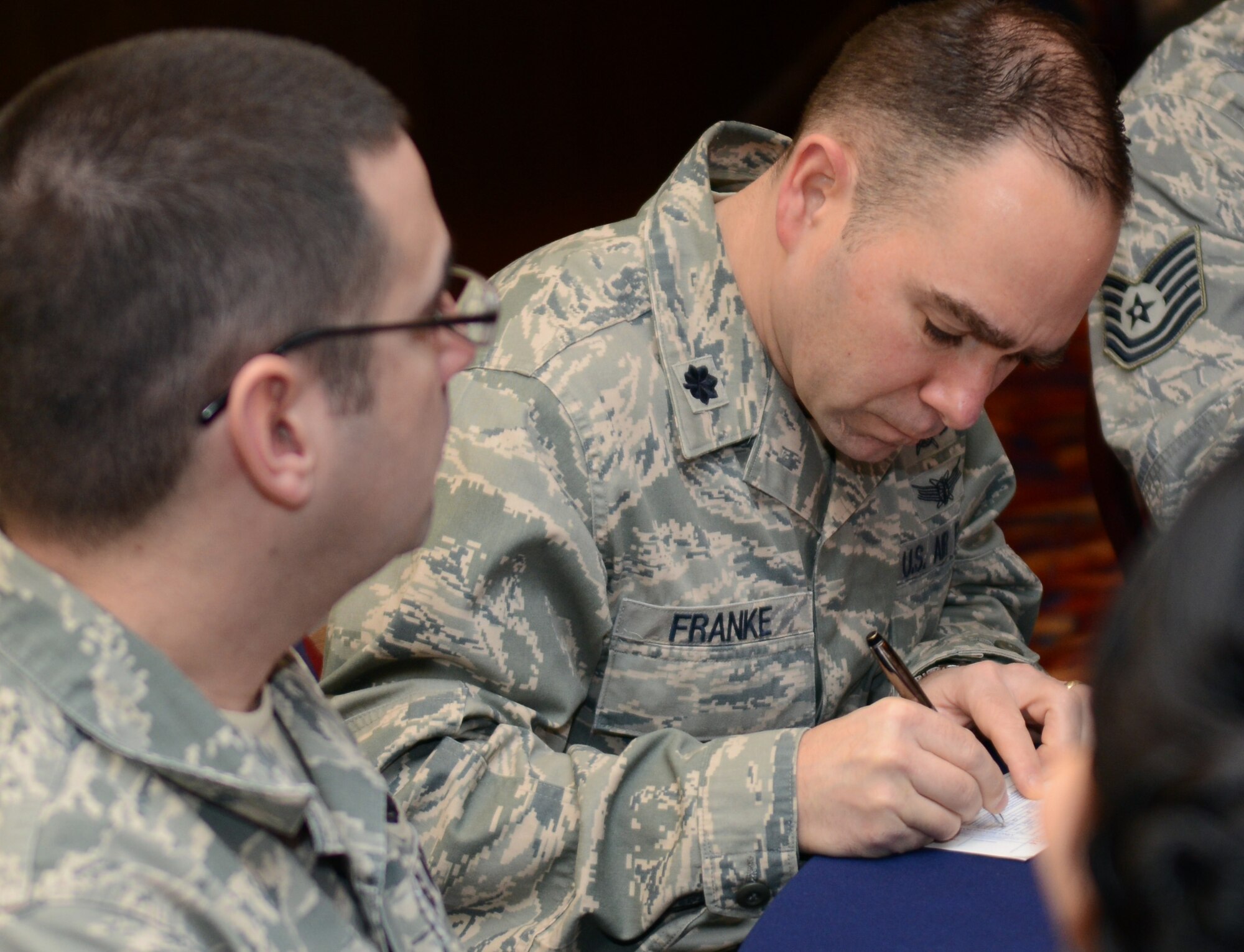 U.S. Air Force Lt. Col. Albert Franke, 100th Communications Squadron commander, signs his 2014 Air Force Assistance Fund pledge March 3, 2014, during the AFAF Kickoff Breakfast on RAF Mildenhall, England. The base raised more than $80,000 in 2013, which was 134 percent of its goal. The AFAF is an annual fundraiser and provides funds for Airmen in need of assistance. (U.S. Air Force photo by Airman 1st Class Jonathan Light/Released)