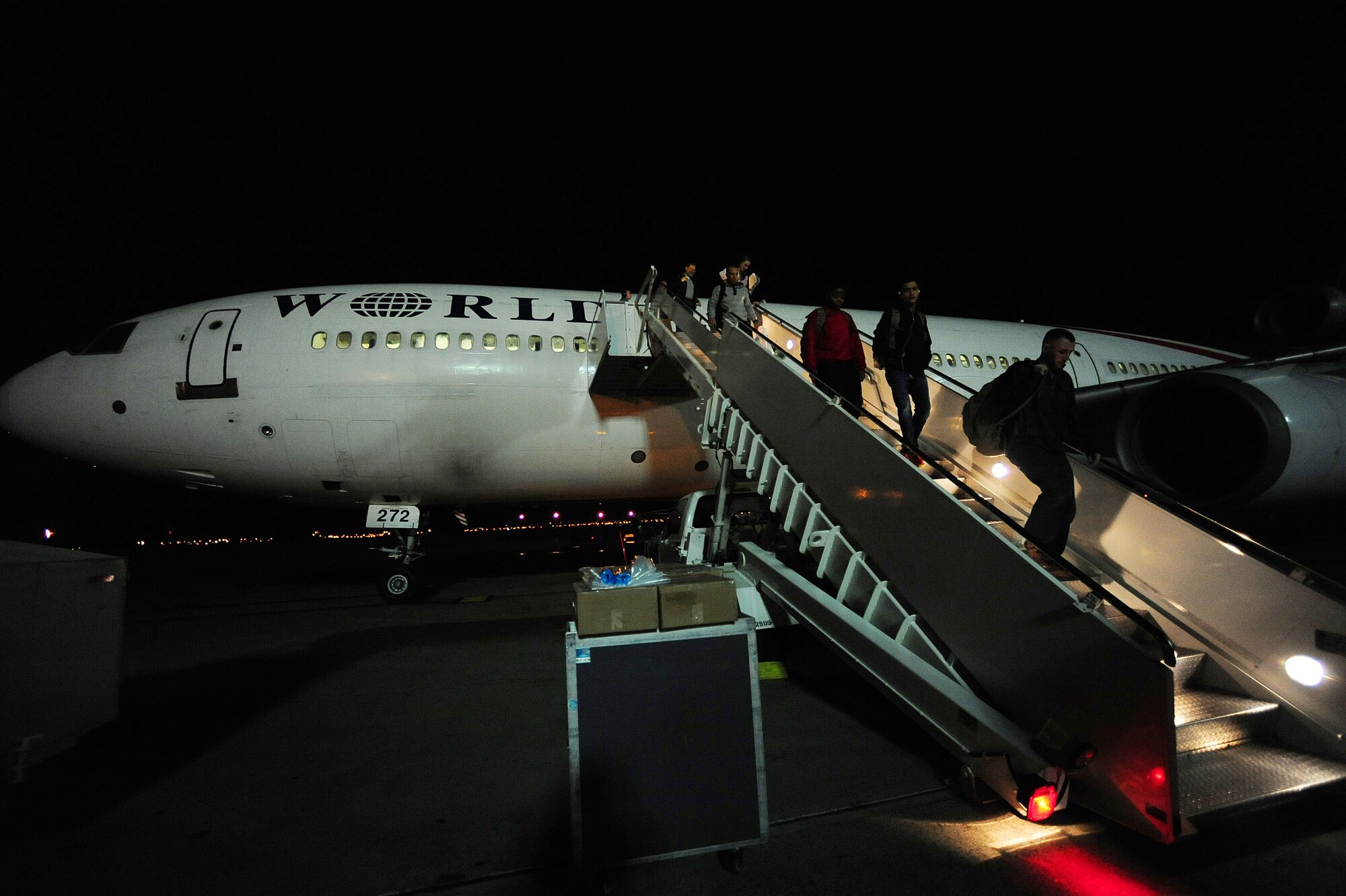 Airmen and families depart the Patriot Express Feb. 25, 2014, Incirlik Air Base, Turkey. The 728th Air Mobility Squadron Passenger terminal processes hundreds of passengers weekly. The PAX terminal offers military members, DoD civilians and their dependents the opportunity to fly at a discounted rate, if there is space available on pre-existing flights. (U.S. Air Force photo by Senior Airman Nicole Sikorski/Released) 