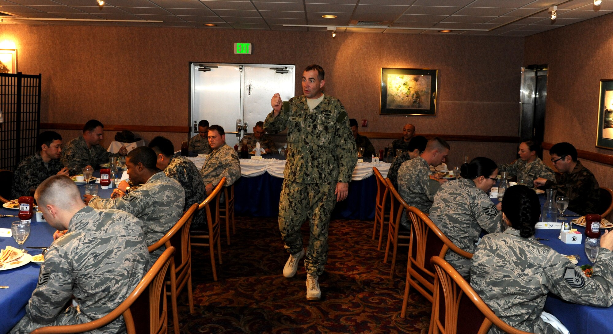 U.S. Navy Command Master Chief Mark W. Rudes, Pacific Command senior enlisted leader, speaks to Airmen, Soldiers, Marines, and Japan Air Self Defense Force members at the Rocker NCO club during his visit to Kadena Air Base, Japan, Feb. 28, 2014. During his visit, Rudes spoke about budget cuts, force reductions and the need for service members to understand the strategic importance of Okinawa and the necessity to demonstrate good ambassadorship. (U.S. Air Force photo by Airman 1st Class Keith James)