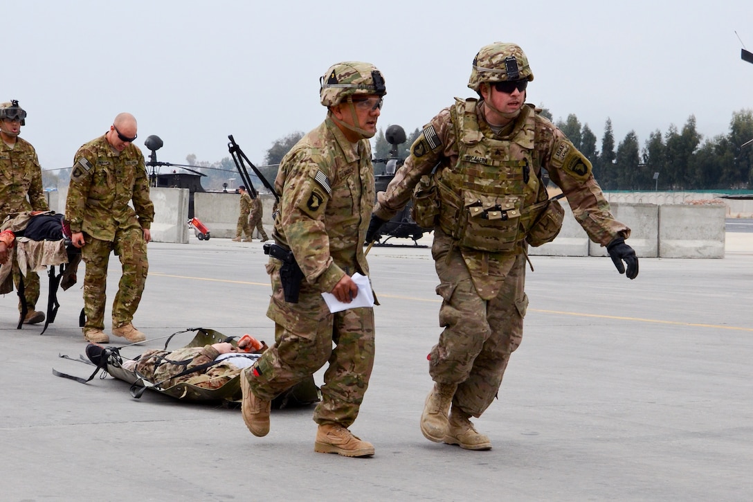 U.S. soldiers pull a simulated wounded soldier toward a UH-60 Black Hawk medevac helicopter during a mass casualty exercise on Forward Operating Base Fenty, Afghanistan, Feb. 26, 2014.