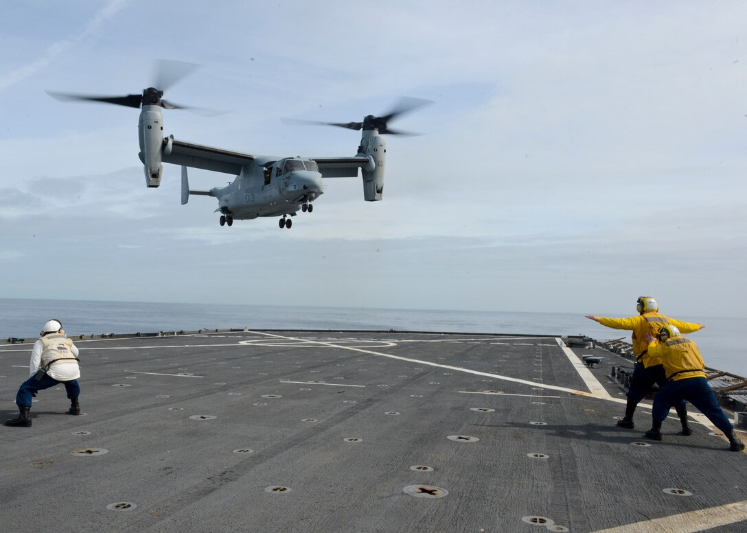 Boatswain’s Mate 2nd Class James Corbett directs a MV-22 Osprey as it conducts carrier qualification aboard the amphibious dock landing ship USS Gunston Hall (LSD-44). The carrier qualification gave the pilots from Special-Purpose Marine Air-Ground Task Force Crisis Response and the Spanish Maneuver Helicopter Battalion #4 a dedicated opportunity to practice fundamental skills associated with operating carrier-based aircraft and demonstrate acceptable levels of proficiency.