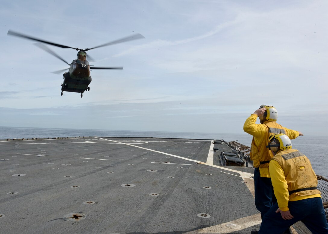 Boatswain’s Mate 2nd Class James Corbett directs an H-47 Chinook, from the Spanish Army, as it conducts carrier qualification aboard the amphibious dock landing ship USS Gunston Hall (LSD-44). The carrier qualification gave the pilots from Special-Purpose Marine Air-Ground Task Force Crisis Response and the Spanish Maneuver Helicopter Battalion #4 a dedicated opportunity to practice fundamental skills associated with operating carrier-based aircraft and demonstrate acceptable levels of proficiency.