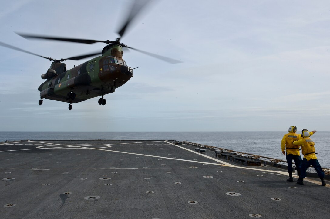 Boatswain’s Mate 2nd Class James Corbett directs an H-47 Chinook, from the Spanish Army, as it takes off aboard the amphibious dock landing ship USS Gunston Hall (LSD-44). The carrier qualification gave the pilots from Special-Purpose Marine Air-Ground Task Force Crisis Response and Spanish Maneuver Helicopter Battalion #4 a dedicated opportunity to practice fundamental skills associated with operating carrier-based aircraft and demonstrate acceptable levels of proficiency.