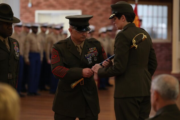 Sgt. Maj. Gary Buck turns in his sword of office to Brig. Gen. Lori Reynolds, commanding general of Marine Corps Recruit Depot Parris Island, S.C., on Feb. 21, 2014, as part of a relief and appointment ceremony for the Marine Corps Recruit Depot Parris Island and Eastern Recruiting Region sergeant major. Buck retired after 29 years of service to the Corps and was replaced by Sgt. Maj. Paul Archie. 