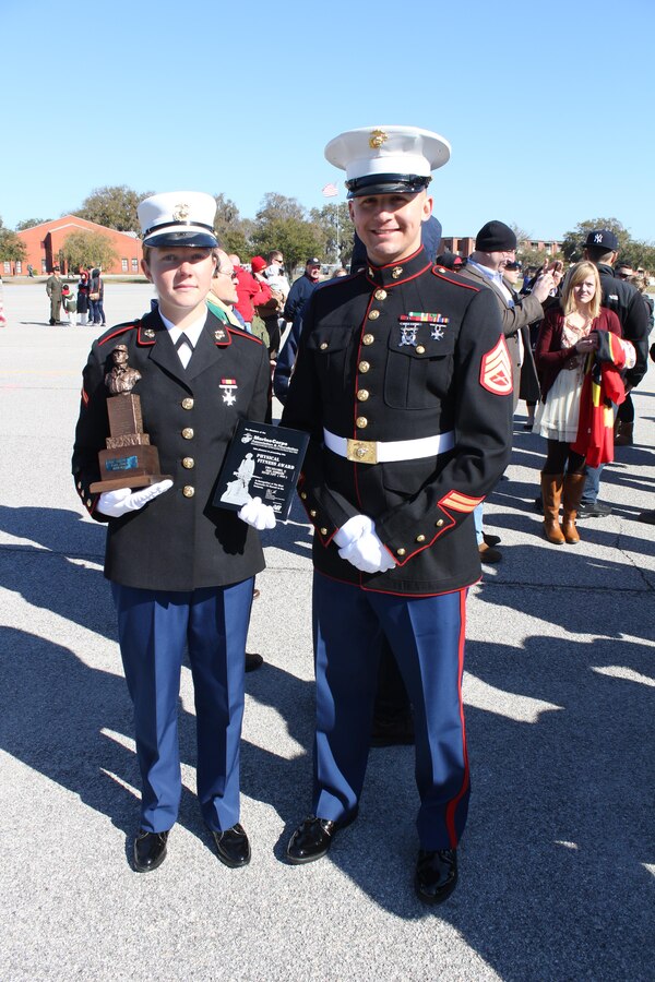 U.S. Marine Corps Pfc. Callahan Brown, the Company Honor Graduate from Platoon 4007, Papa Co., 4th Recruit Training Battalion, stands with Staff Sgt. Craig Taylor after graduattion Feb. 28, 2014.  She was recruited out of Recruiting Station Frederick by Taylor. (U.S. Marine Corps photo by Cpl. Nicholas S. Ranum/Released)
