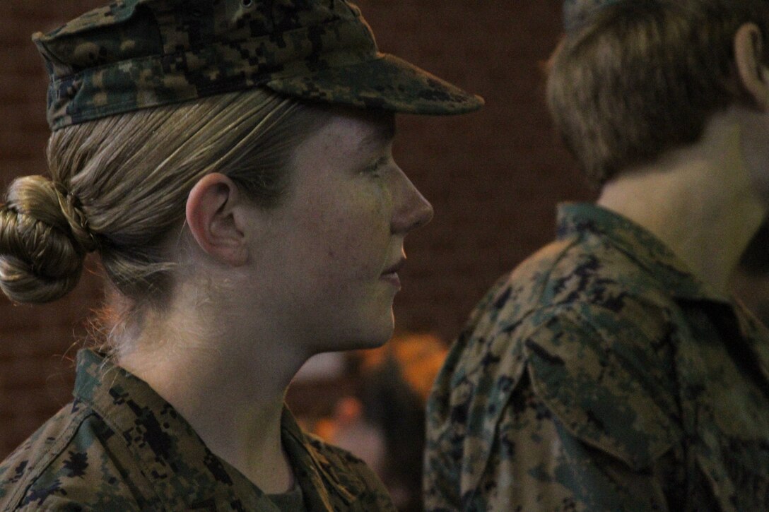 U.S. Marine Corps Pfc. Callahan Brown pays close attention to the rifle cleaning instructions as she prepares to graduate recruit training as the Company Honor Graduate for of Platoon 4007, Papa Co., 4th Recruit Training Battalion, Feb. 28, 2014.  She was recruited for Recruiting Station Frederick by Staff Sgt. Craig Taylor out of Springfield, Va. (U.S. Marine Corps photo by Sgt. Amber Williams/Released)