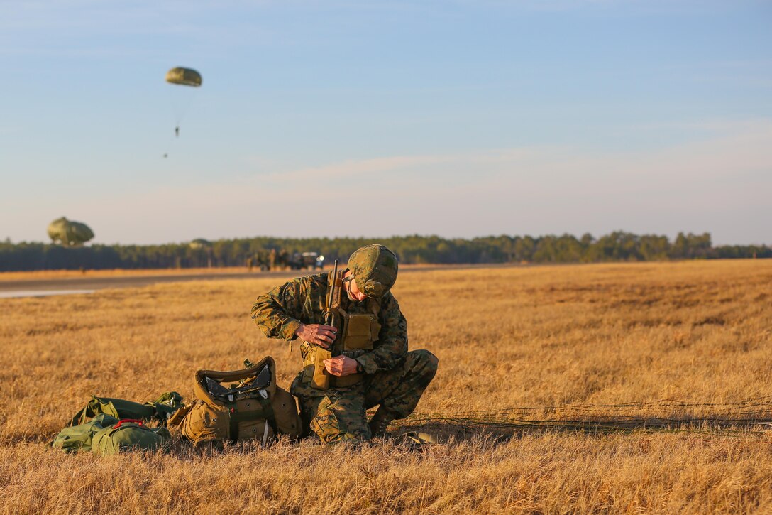 Sergeant Jesse Welch, an assistant team leader with Force Company, 2nd Reconnaissance Battalion, 2nd Marine Division, gathers all of his gear after landing during a field training exercise aboard Marine Corps Base Camp Lejeune, N.C., Feb. 18, 2014. When the Marines land they must immediately ready their weapon, get in contact with their team-members then pack and prepare the rest of the gear. The total weight of their gear is more than 100 pounds. 