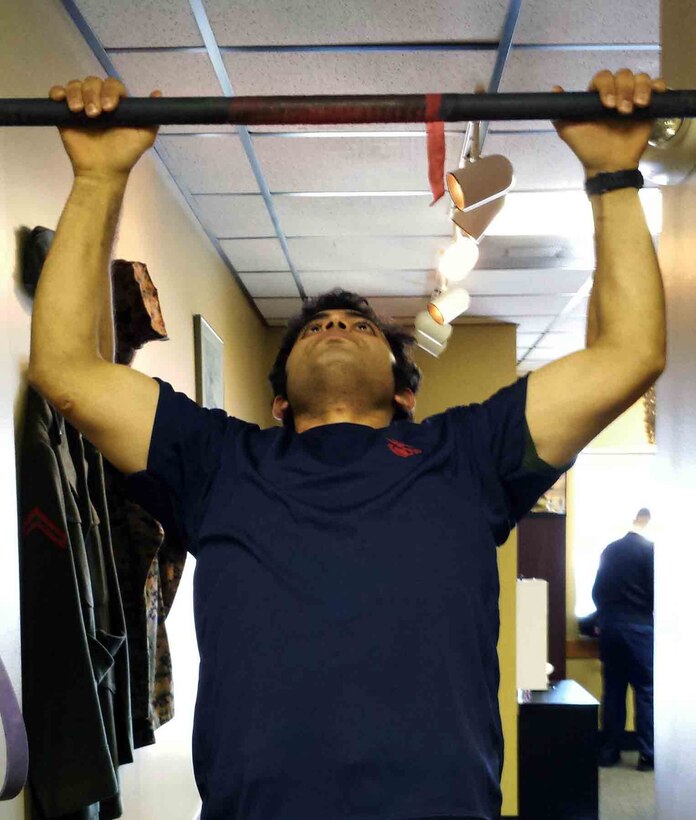 Marine Corps poolee Zaid Alithawi conducts pull ups at his local recruiter's office in Fargo, Minn. Alithawi was born in Iraq and helped U.S. forces with translating as a teenager. Since then he has dreamed of becoming a U.S. Marine. After moving to America and enlisting out of Marine Corps Recruiting Station Twin Cities, he departed for Marine Corps Recruit Training, March 4. 