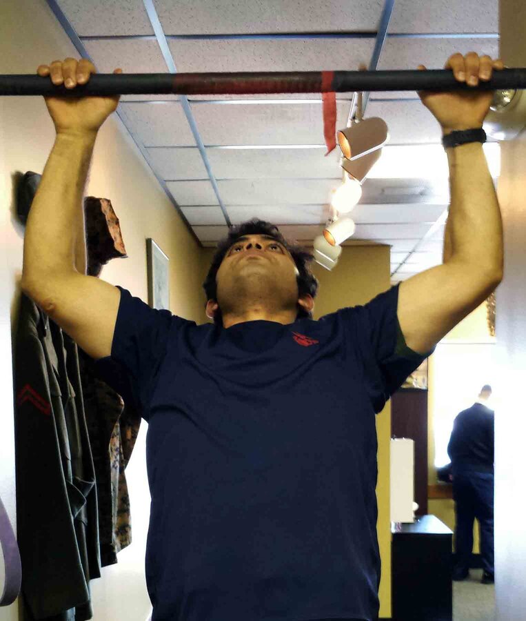Marine Corps poolee Zaid Alithawi conducts pull ups at his local recruiter's office in Fargo, Minn. Alithawi was born in Iraq and helped U.S. forces with translating as a teenager. Since then he has dreamed of becoming a U.S. Marine. After moving to America and enlisting out of Marine Corps Recruiting Station Twin Cities, he departed for Marine Corps Recruit Training, March 4. 