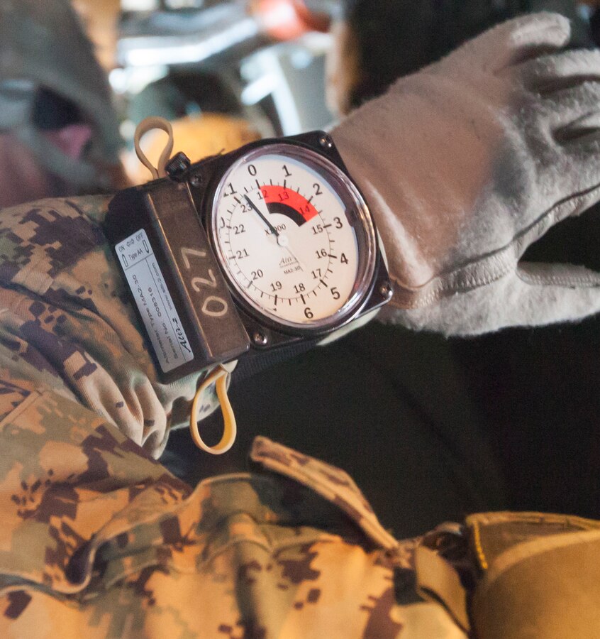 A Marine, with Force Company, 2nd Reconnaissance Battalion, 2nd Marine Division, checks his altimeter when preparing to exit the back of a V-22 Osprey during a jump exercise Feb. 18, 2014 at Marine Corps Base Camp Lejeune, N.C. The altimeter shows the altitude when free falling so the operator can safely deploy his parachute in time. 
