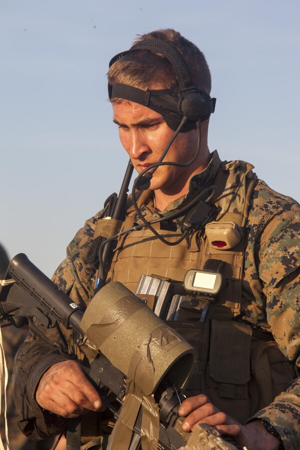Corporal Tyler Ring, a reconnaissance man with Force Company, 2nd Reconnaissance Battalion, 2nd Marine Division, stands guard while his team regrouped after inserting by parachute, and before moving out on a foot patrol during a training exercise at Marine Corps Base Camp Lejeune, N.C., Feb. 18, 2014. Moving more than five miles through the wet, muddy swamplands took the Marines approximately 11 hours to complete. 