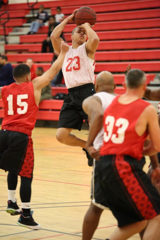 Deontra Gowdy, an Enlisted Instructor Platoon player, shoots during an intramural basketball game against the Weapons Training Battalion at the Barber Physical Fitness Activity on Feb. 25, 2014. WTBN won 52-34. 