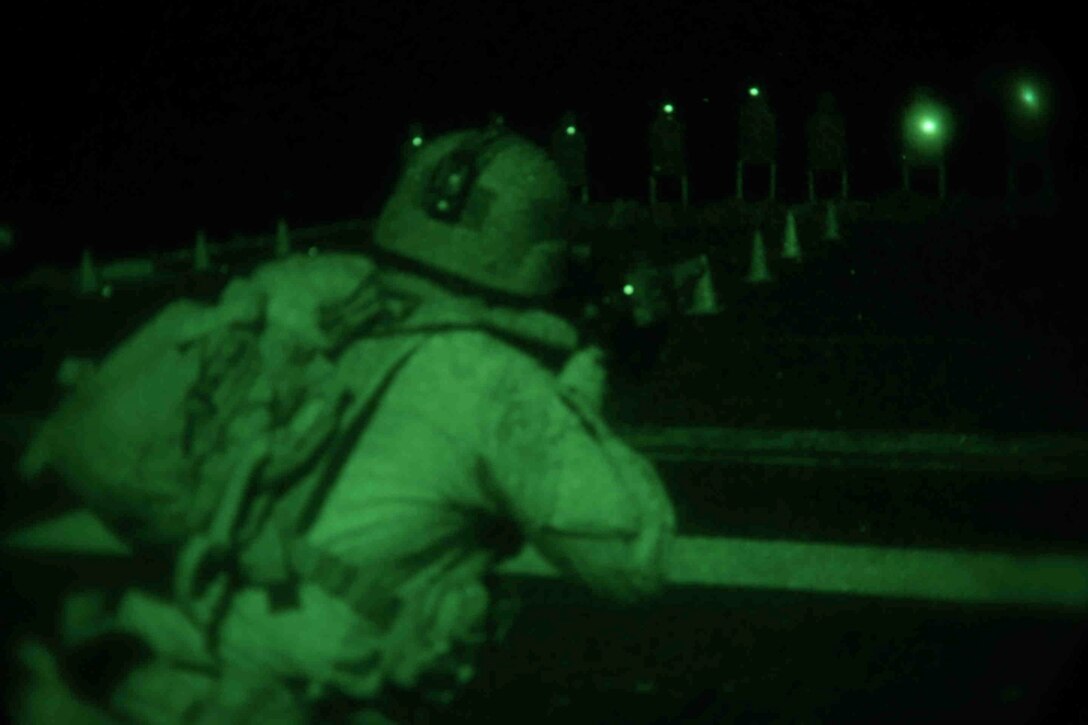 A U.S. Marines assigned to Reconnaissance Platoon, Battalion Landing Team 1/4, 13th Marine Expeditionary Unit (MEU), participates in a live night fire aboard USS Boxer (LHD 4), Feb. 24, 2014. The 13th MEU is deployed with the Boxer Amphibious Ready Group as a theater reserve and crisis response force throughout the U.S. 5th Fleet area of responsibility. (U.S. Marine Corps photo by Gunnery Sgt. Ajiboye Magbagbeola, 13th Marine Expeditionary Unit Combat Camera/Released)