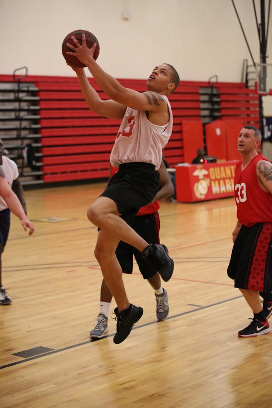 Deontra Gowdy, an Enlisted Instructor Platoon player, attempts a layup during an intramural basketball game against the Weapons Training Battalion at the Barber Physical Fitness Activity on Feb. 25, 2014. WTBN won 52-34.