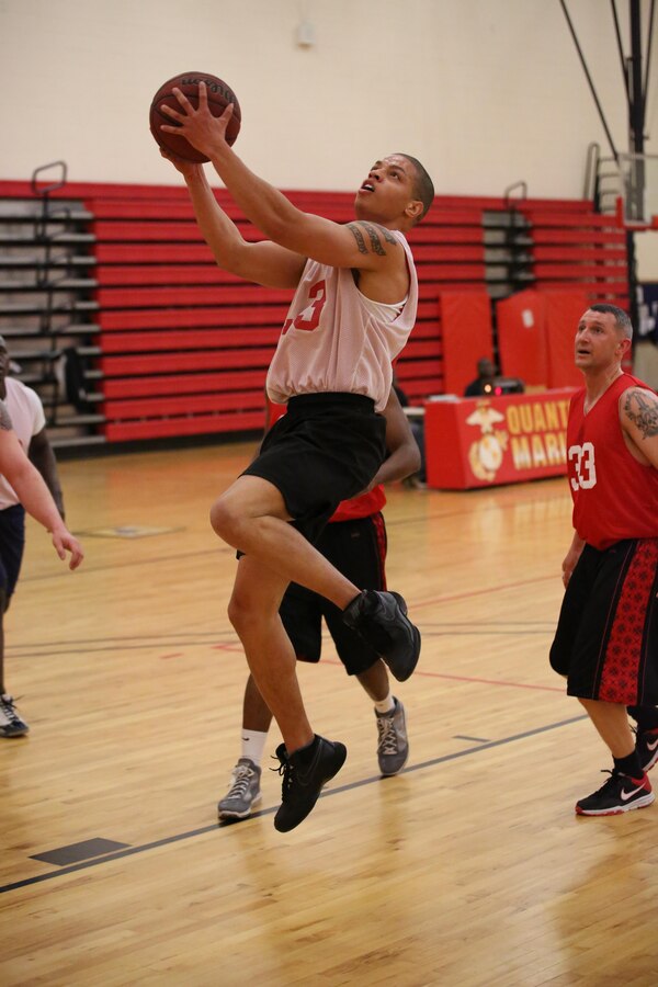 Deontra Gowdy, an Enlisted Instructor Platoon player, attempts a layup during an intramural basketball game against the Weapons Training Battalion at the Barber Physical Fitness Activity on Feb. 25, 2014. WTBN won 52-34.