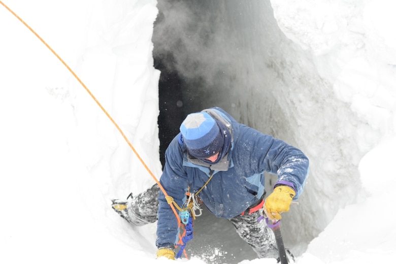 A traverse mountaineer climbs into the second traverse that had had the snow bridge blown off to investigate.  This crevasse was not as large as the first, measuring approximately 80 feet deep, with an approximate 10-foot wide bridge.  However, this one had another very large crevasse running perpendicular to it.