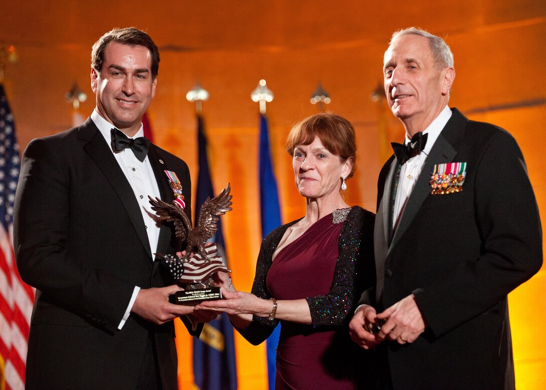 U.S. Marine Corps retired Lt. Col. Robert Riggle, Jr., left, receives the Reserve Officers Association STARS Image Award, presented by retired Maj. Gen. Andrew B. Davis, right, during the ROA Stars Foundation Gala in Washington, D.C., March 4, 2014. (U.S. Marine Corps photo by Cpl. Tia Dufour/Released)
