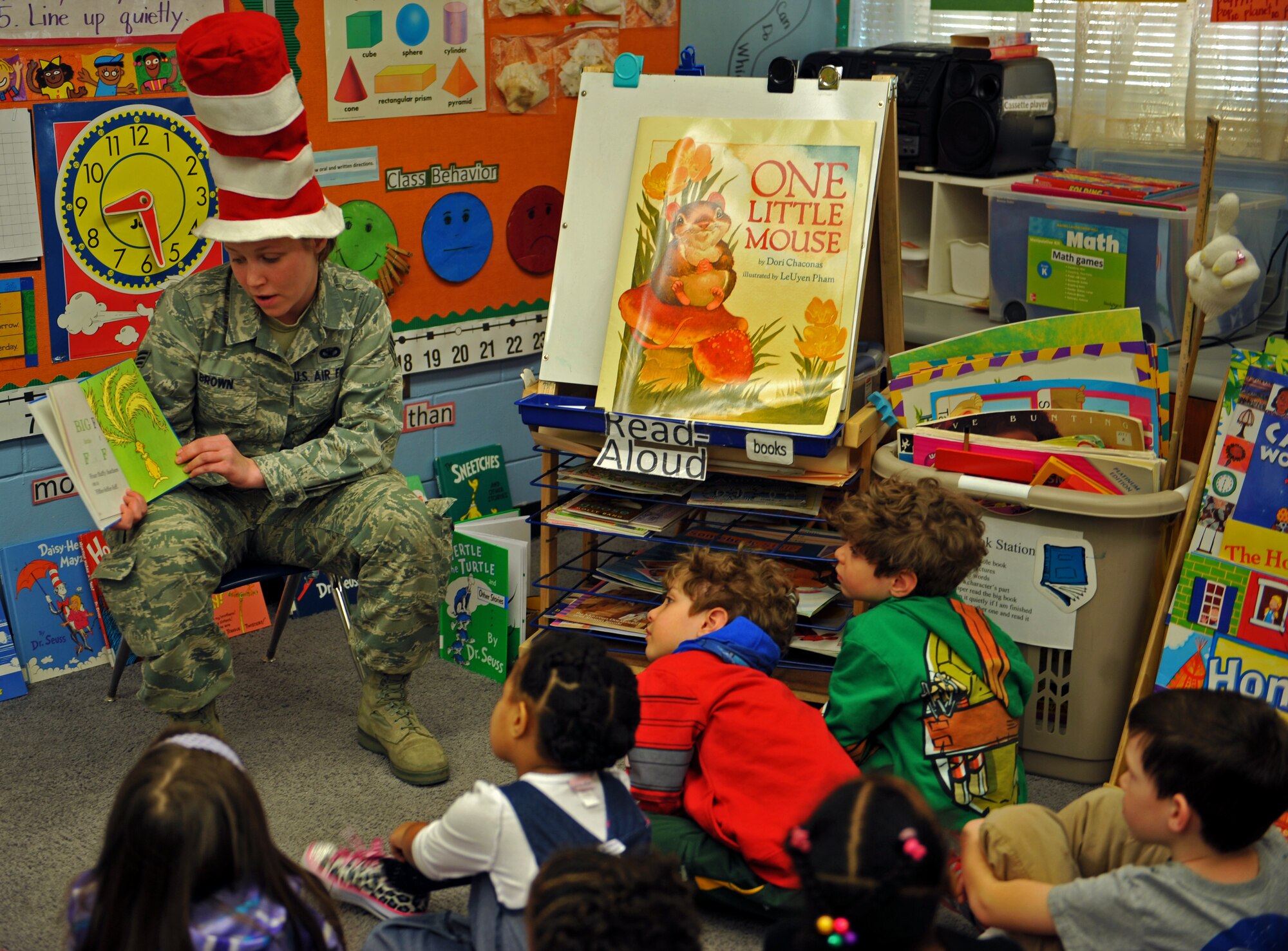 Senior Airman Stevie Brown, a member of the 51st Security Forces Squadron, reads a book to kindergarten students during Read Across America Day in celebration of Dr. Seuss’ Birthday at Osan Air Base, Republic of Korea, March 5, 2014. More than 50 Team Osan military members volunteered to read to 21 Osan American Elementary School classes. (U.S. Air Force photo/Senior Airman Siuta B. Ika)