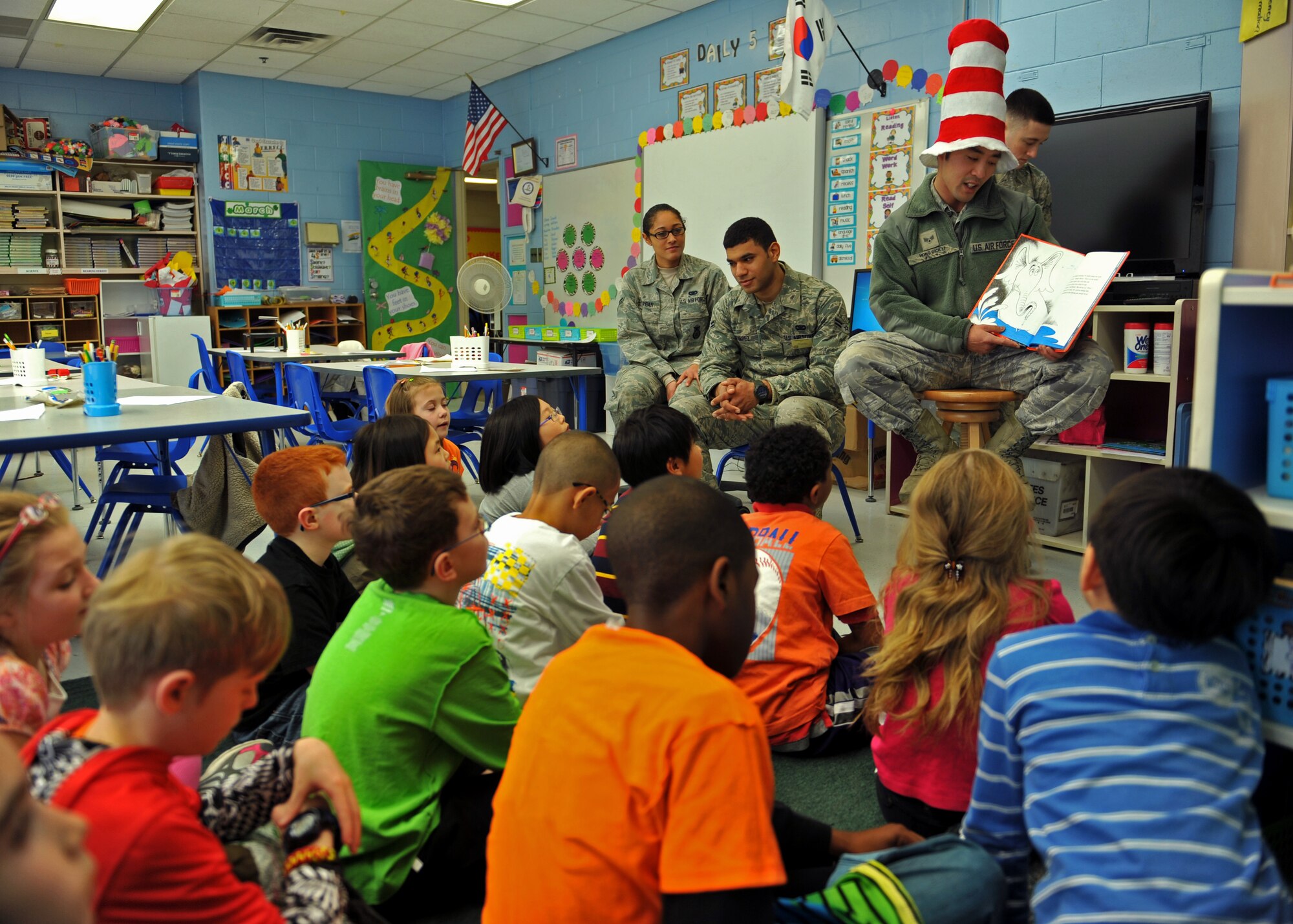 Senior Airman Hong Dick Li, a member of the 51st Security Forces Squadron, reads a book to third-grade students during Read Across America Day in celebration of Dr. Seuss’ Birthday at Osan Air Base, Republic of Korea, March 5, 2014. Li and other Airmen read to multiple Osan American Elementary School students in kindergarten through fifth grade. (U.S. Air Force photo/Senior Airman Siuta B. Ika)